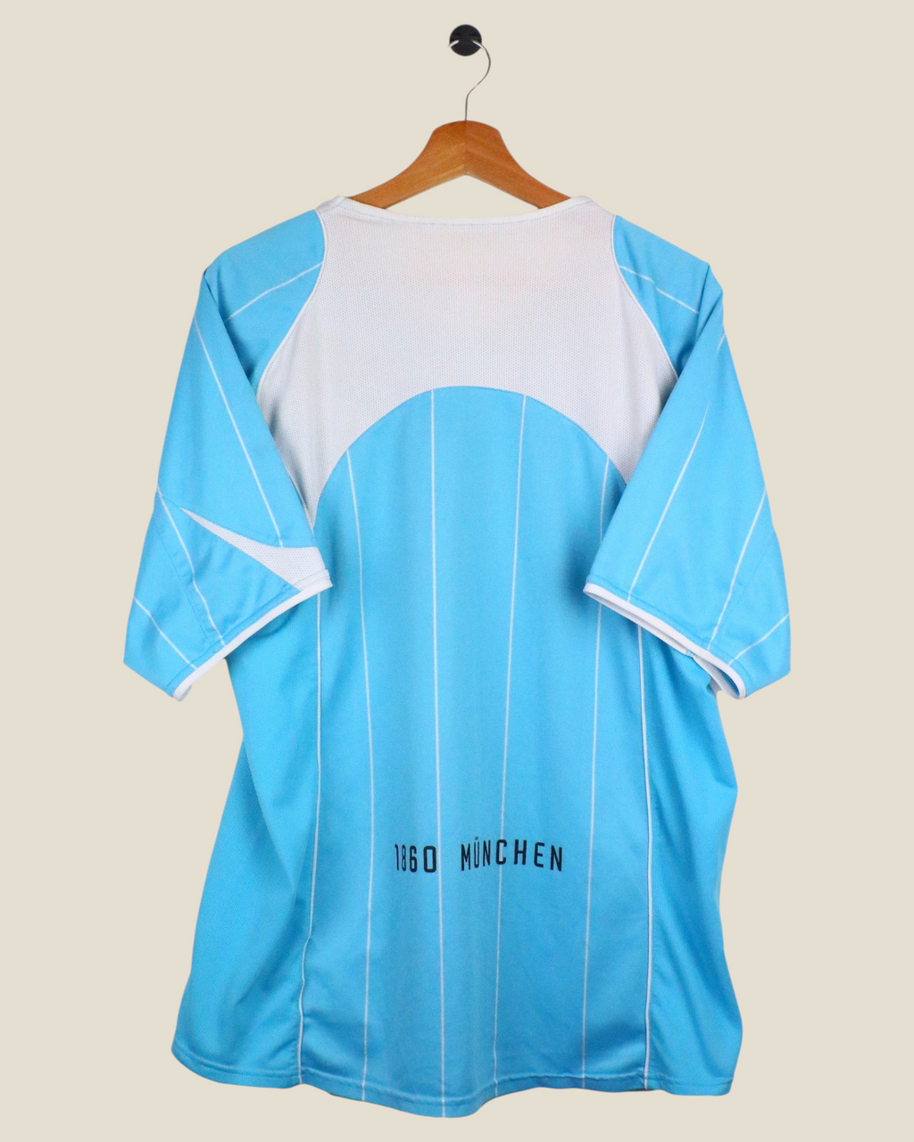 Kick Off Vintage 1860 Munchen 2004/05 home football shirt in light blue and white, back view on a hanger.