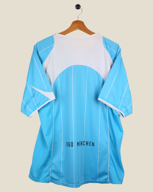Kick Off Vintage 1860 Munchen 2004/05 home football shirt in light blue and white, back view on a hanger.