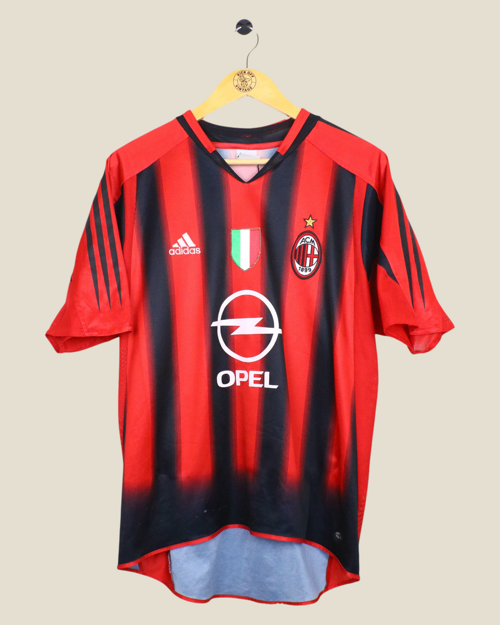 Kick Off Vintage AC Milan 2004/05 home jersey by Adidas, featuring red and black stripes and iconic Opel sponsor.
