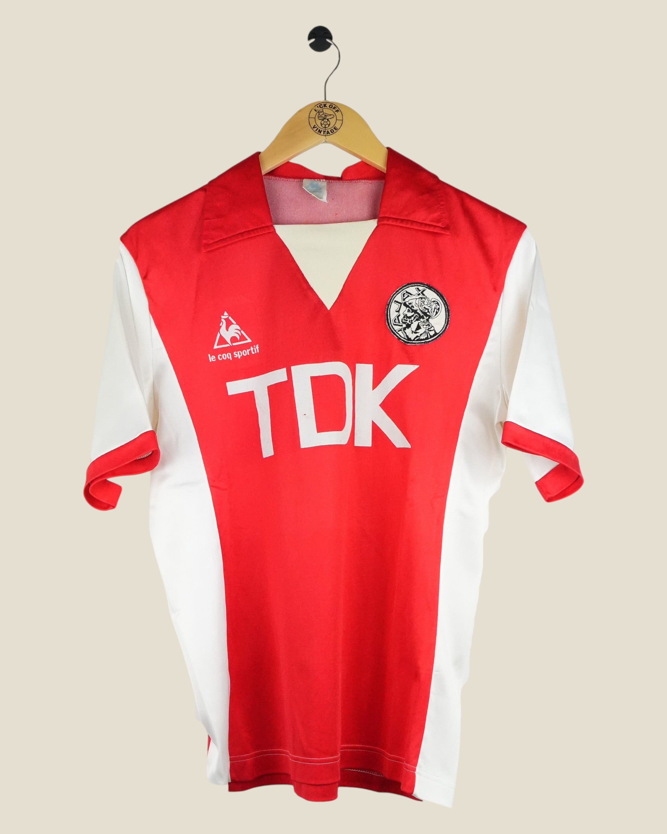 Kick Off Vintage Ajax 1982/83 home football shirt by Le Coq Sportif, featuring red and white design with TDK sponsor