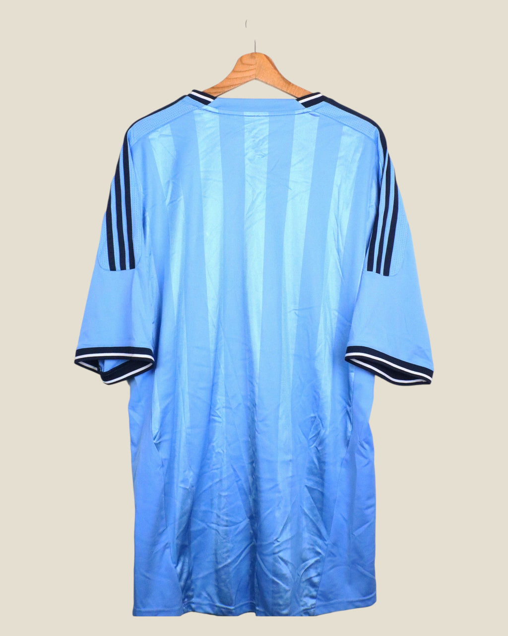 Kick Off Vintage Ajax 2011/12 away football shirt in light blue with navy Adidas stripes on a wooden hanger