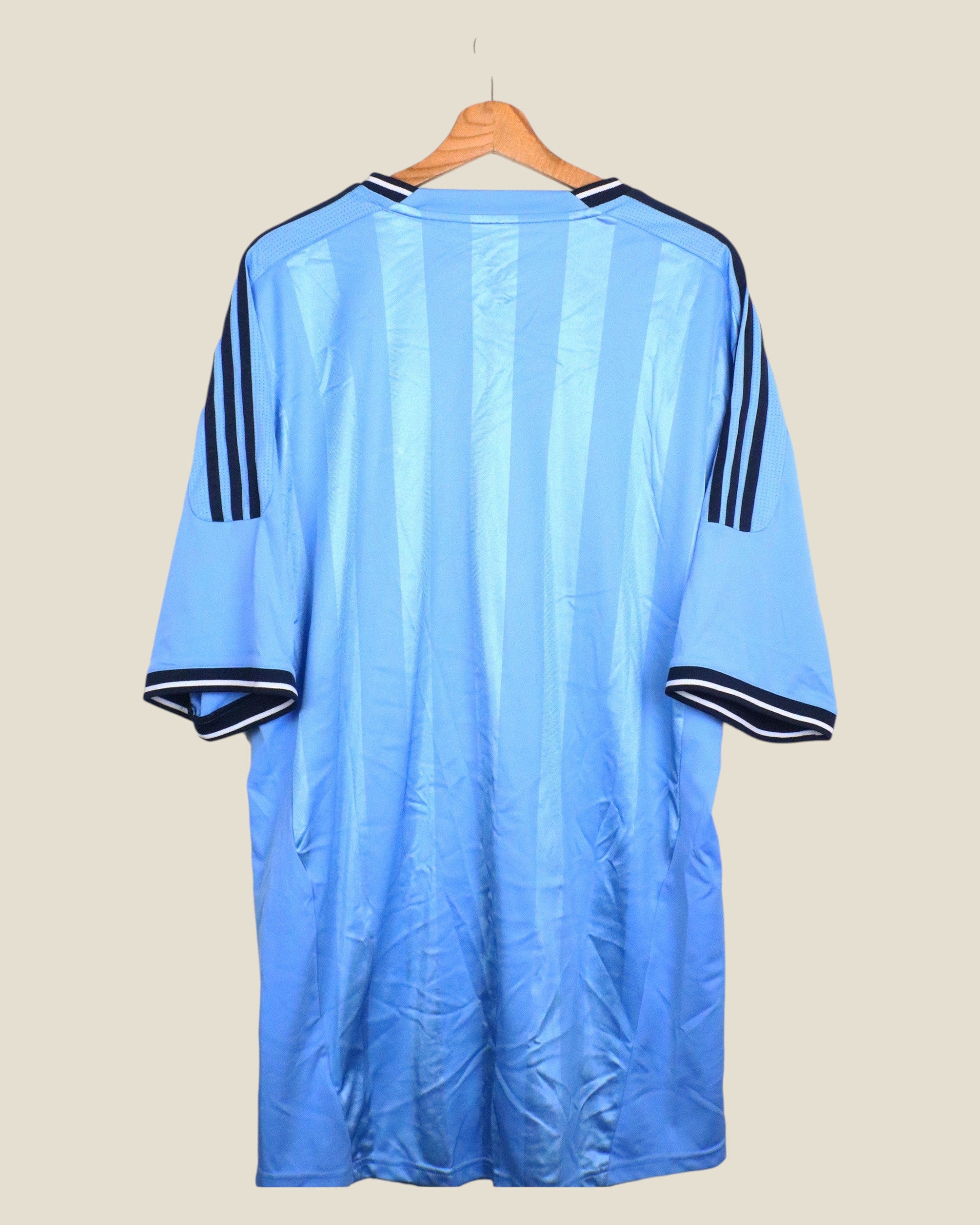 Kick Off Vintage Ajax 2011/12 away football shirt in light blue with navy Adidas stripes on a wooden hanger