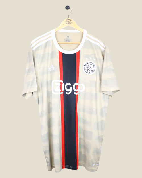 Kick Off Vintage Ajax 2022/23 third football jersey featuring Tadic, beige with a central red and black stripe.