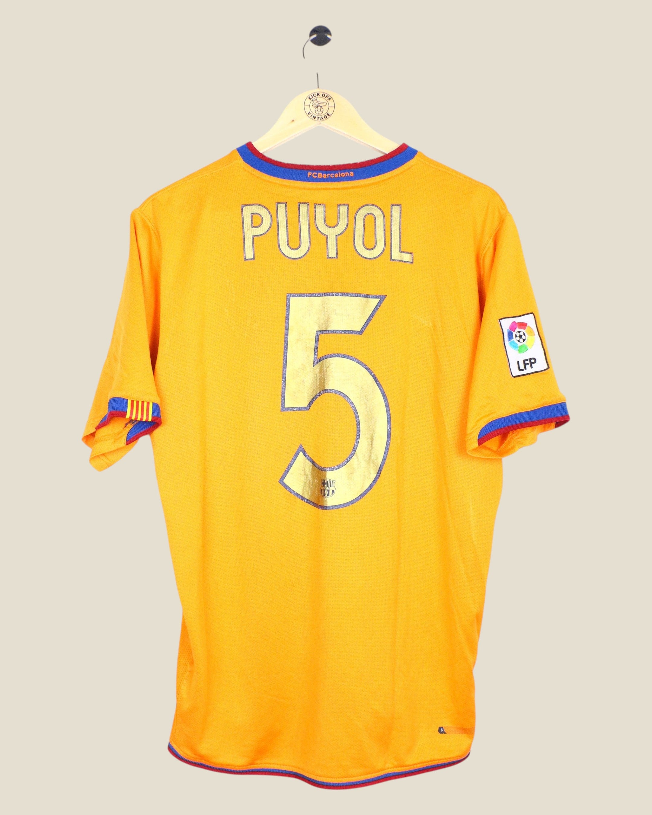 Kick Off Vintage Barcelona 2006/07 away jersey featuring Puyol number 5 on the back in yellow with blue and red trim.