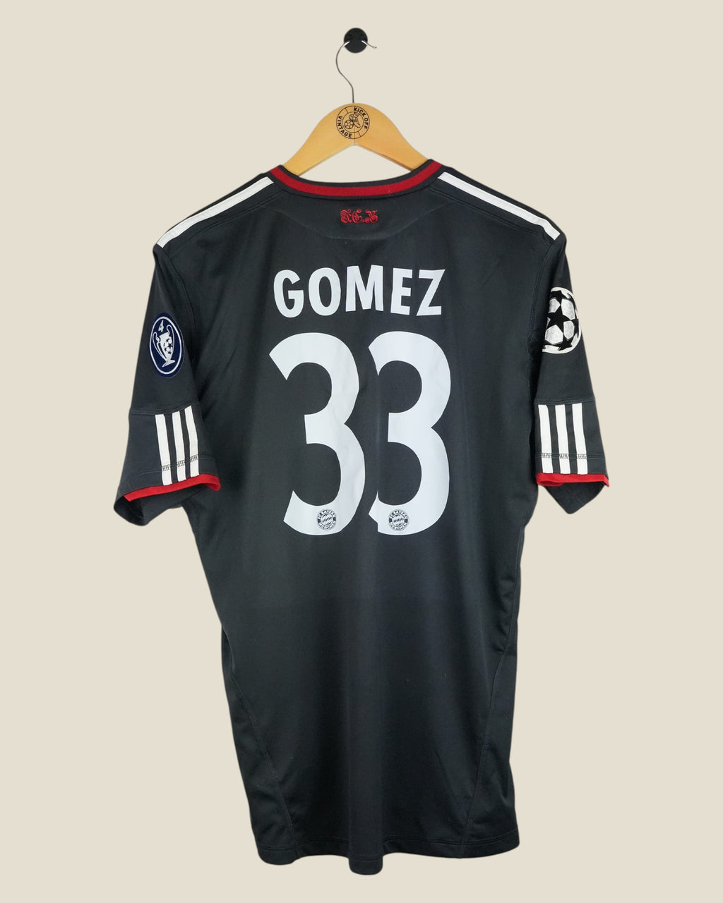 Kick Off Vintage Bayern Munich 2010/11 Gomez 33 third jersey in black with white Adidas stripes and Champions League patches