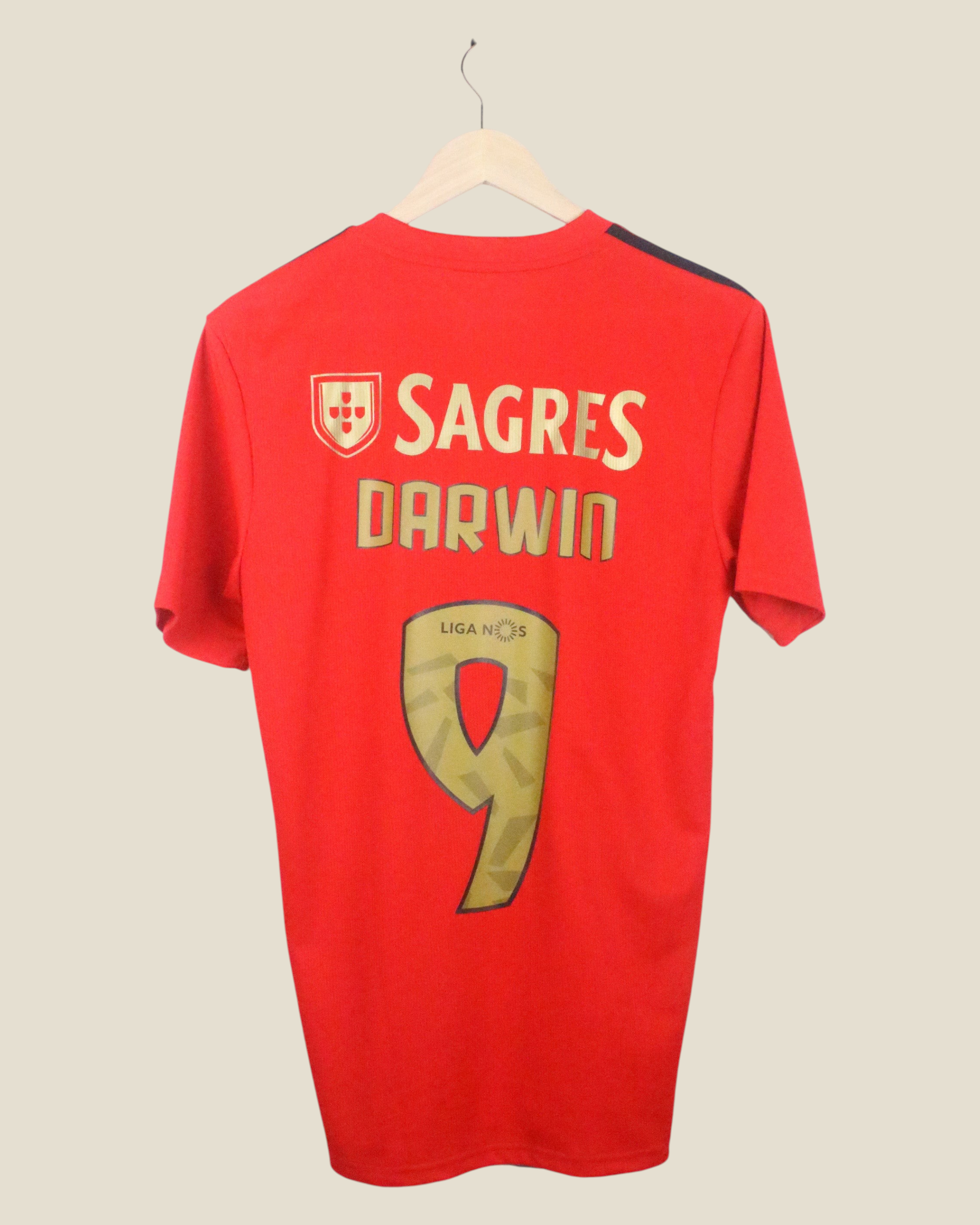 Kick Off Vintage Benfica 2020/21 home jersey with Nunez #9 print in red and gold, hanging on a wooden hanger.