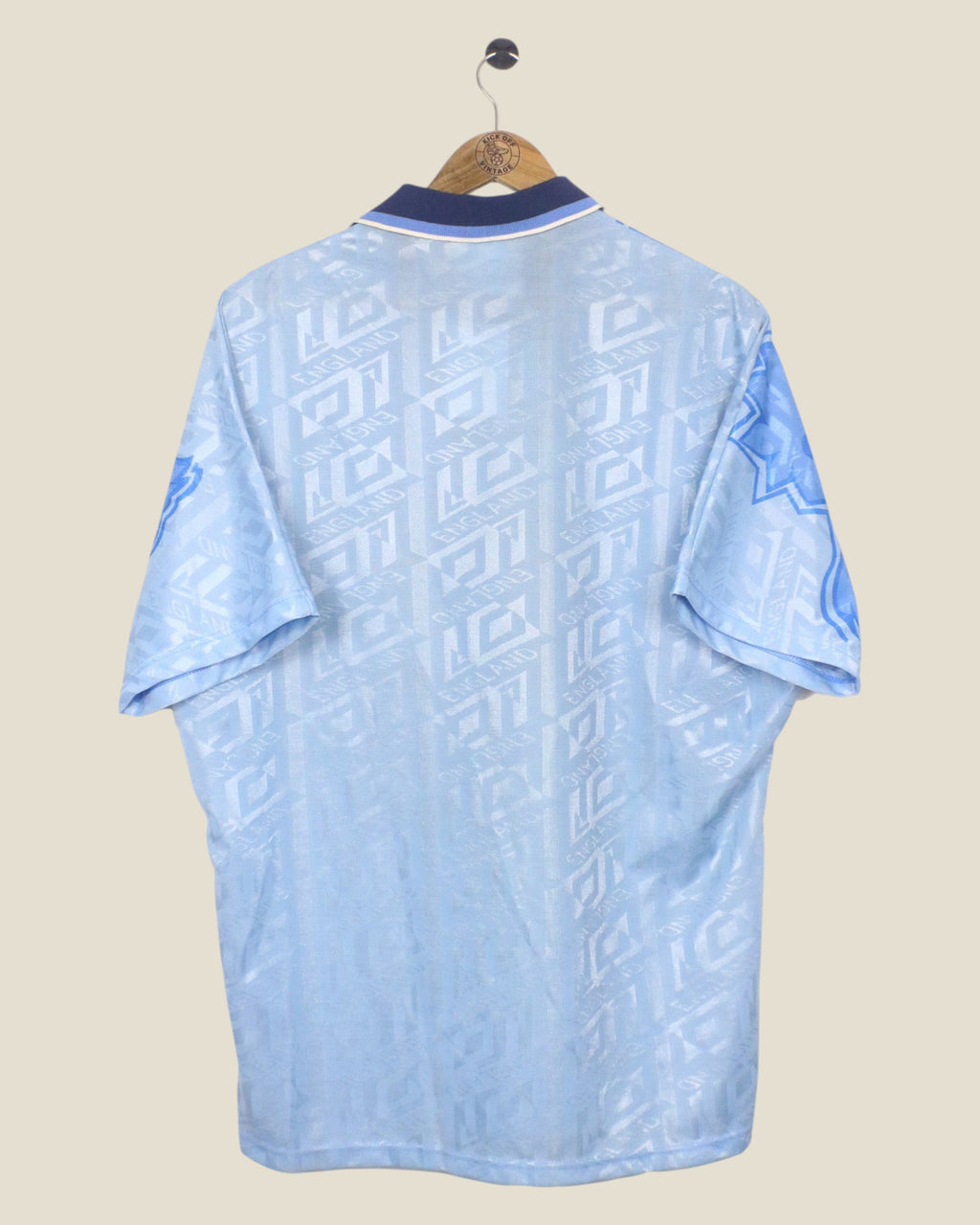 Back view of a vintage Kick Off Vintage England 1992 third football shirt by Umbro in light blue with patterned fabric