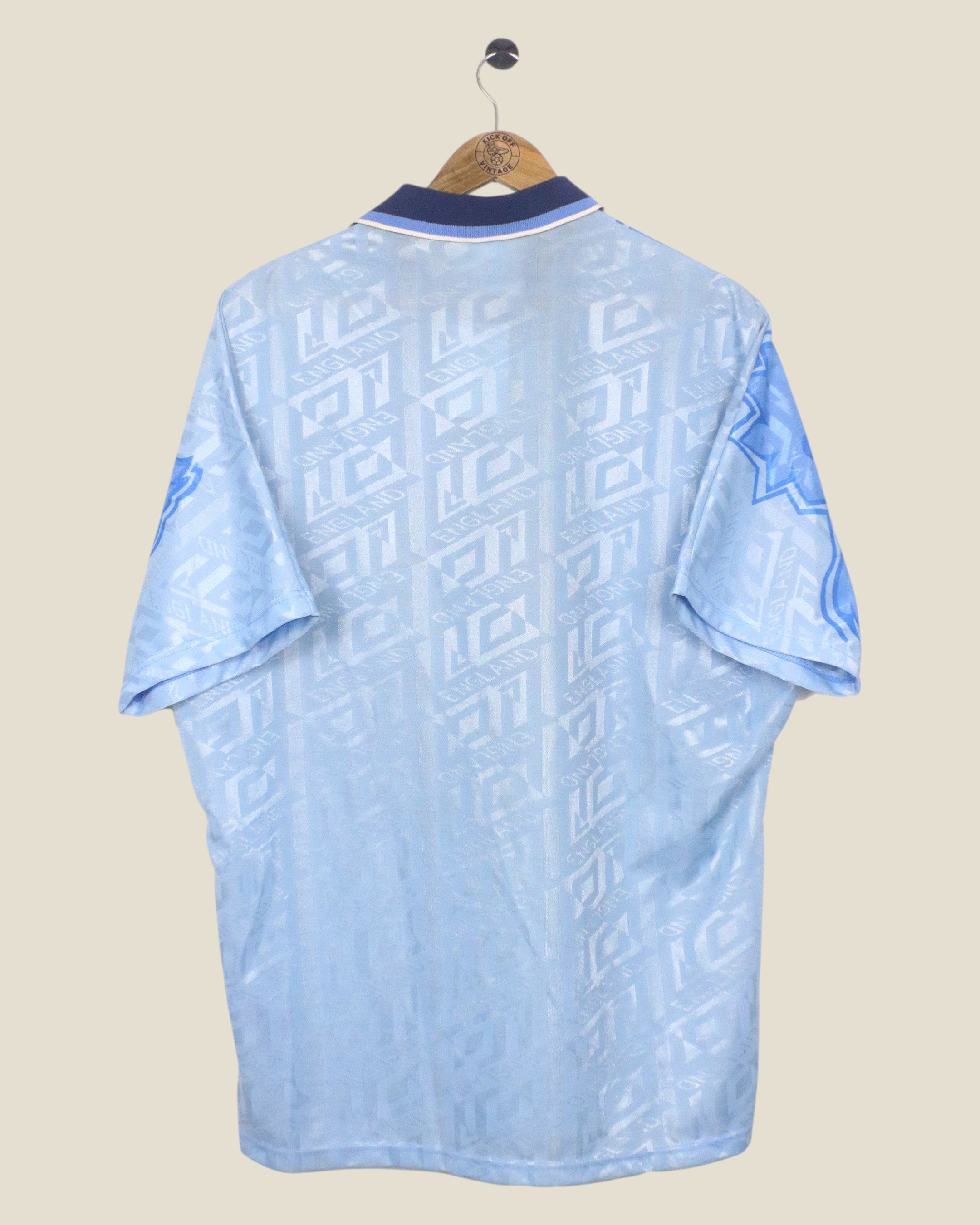 Back view of a vintage Kick Off Vintage England 1992 third football shirt by Umbro in light blue with patterned fabric