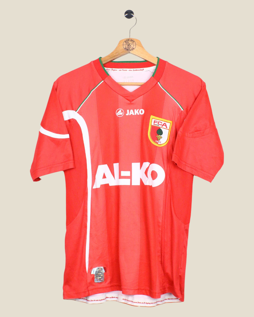 Kick Off Vintage FC Augsburg 2011/12 Jako third football shirt in red with Hosogai player print and team crest.