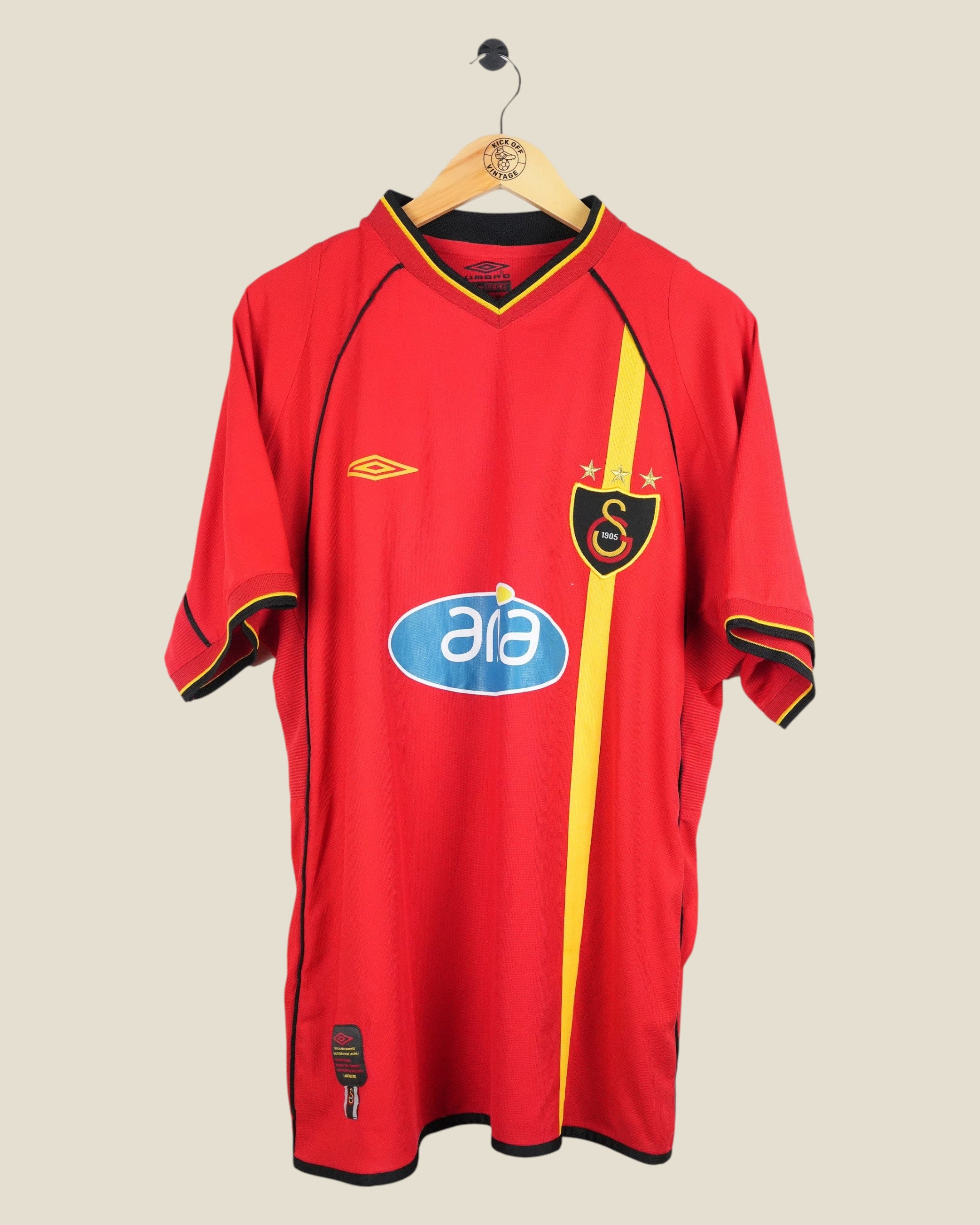 Kick Off Vintage Galatasaray 2002/03 away football shirt in red with yellow vertical stripe and Umbro branding.