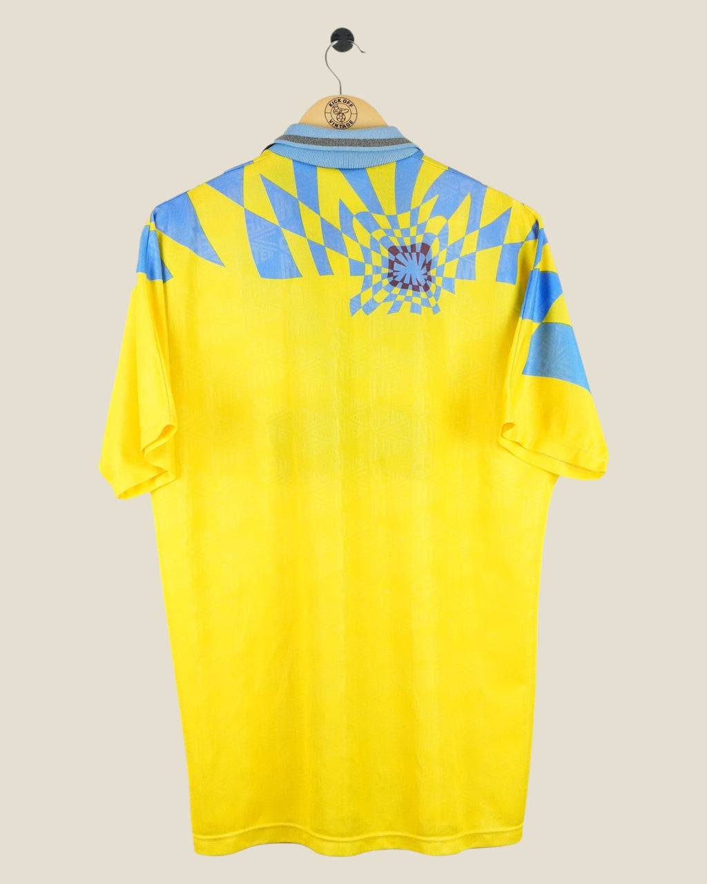 Back view of a vintage yellow and blue Inter Milan 1992/94 third football shirt by Kick Off Vintage on a hanger