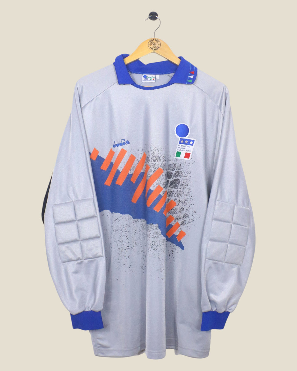 Kick Off Vintage 1992-94 Italy goalkeeper jersey by Diadora in grey with blue collar and orange graphic details.