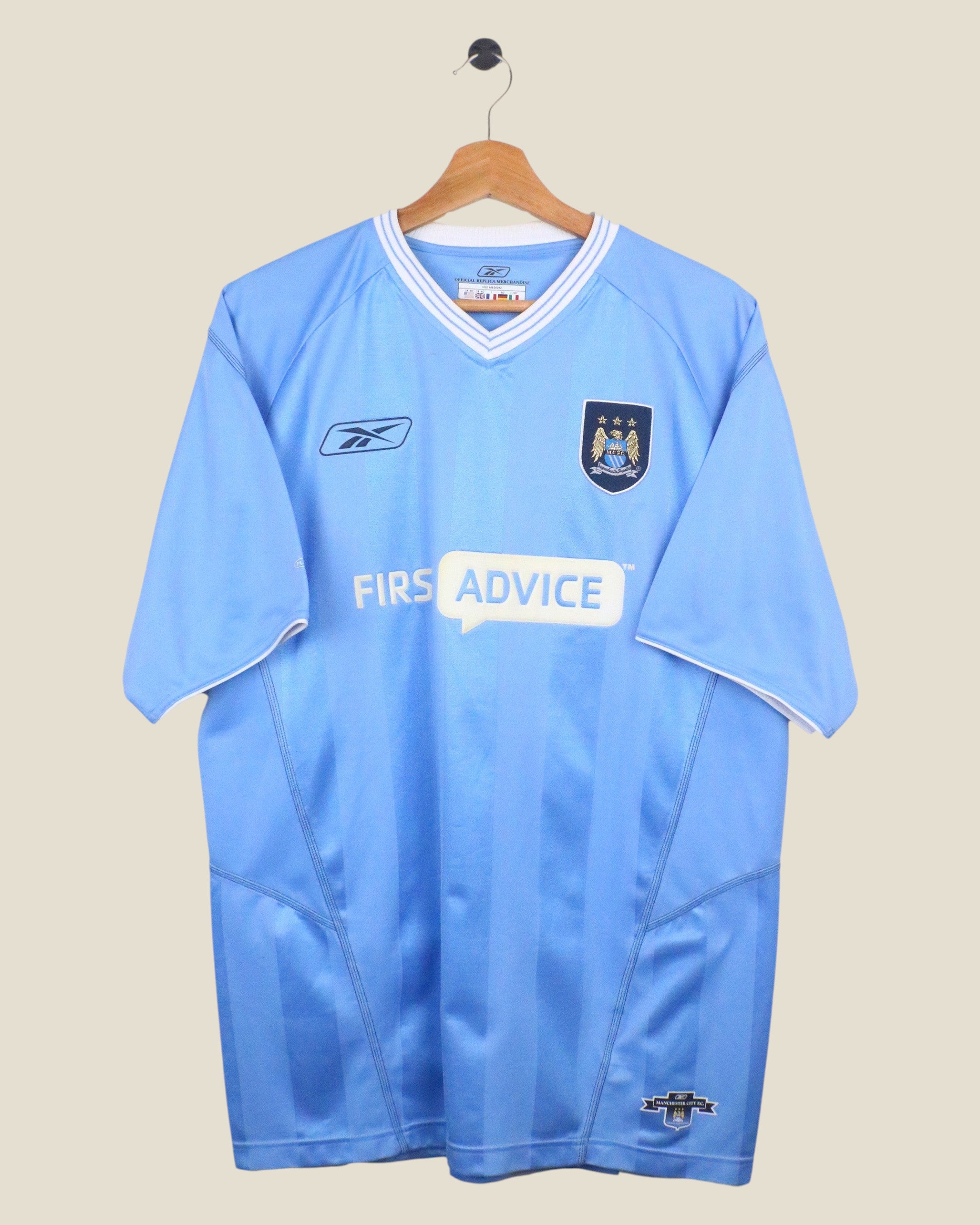 Kick Off Vintage Manchester City 2003/04 home football shirt in sky blue with white trim and Reebok branding.