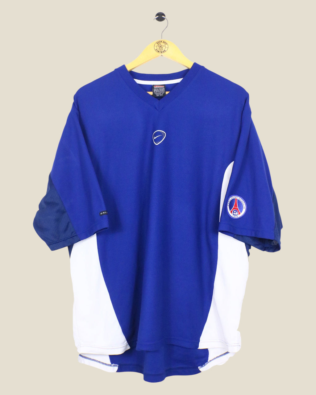 Kick Off Vintage Paris Saint-Germain 2000/01 Nike training shirt in blue and white with V-neck and team crest.