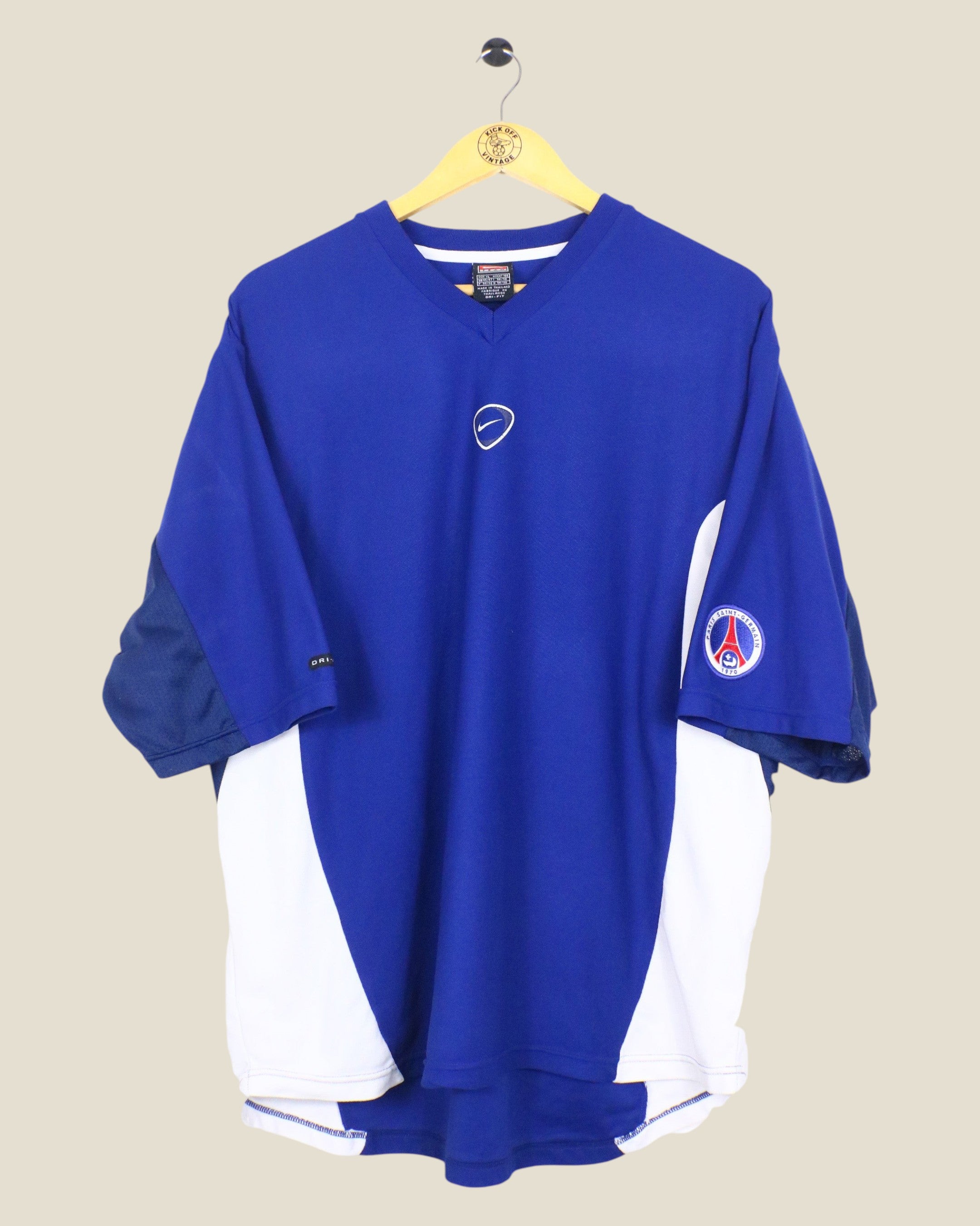 Kick Off Vintage Paris Saint-Germain 2000/01 Nike training shirt in blue and white with V-neck and team crest.