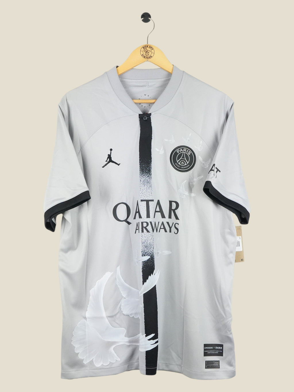 Kick Off Vintage Paris Saint-Germain 2022/23 away jersey in grey with white dove graphics and Air Jordan branding.