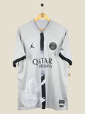 Kick Off Vintage Paris Saint-Germain 2022/23 away jersey in grey with white dove graphics and Air Jordan branding.