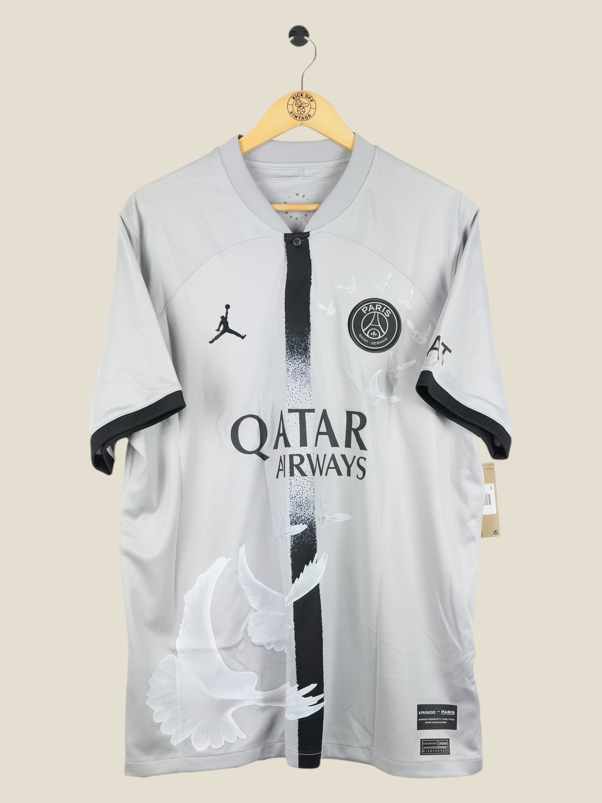 Kick Off Vintage Paris Saint-Germain 2022/23 away jersey in grey with white dove graphics and Air Jordan branding.