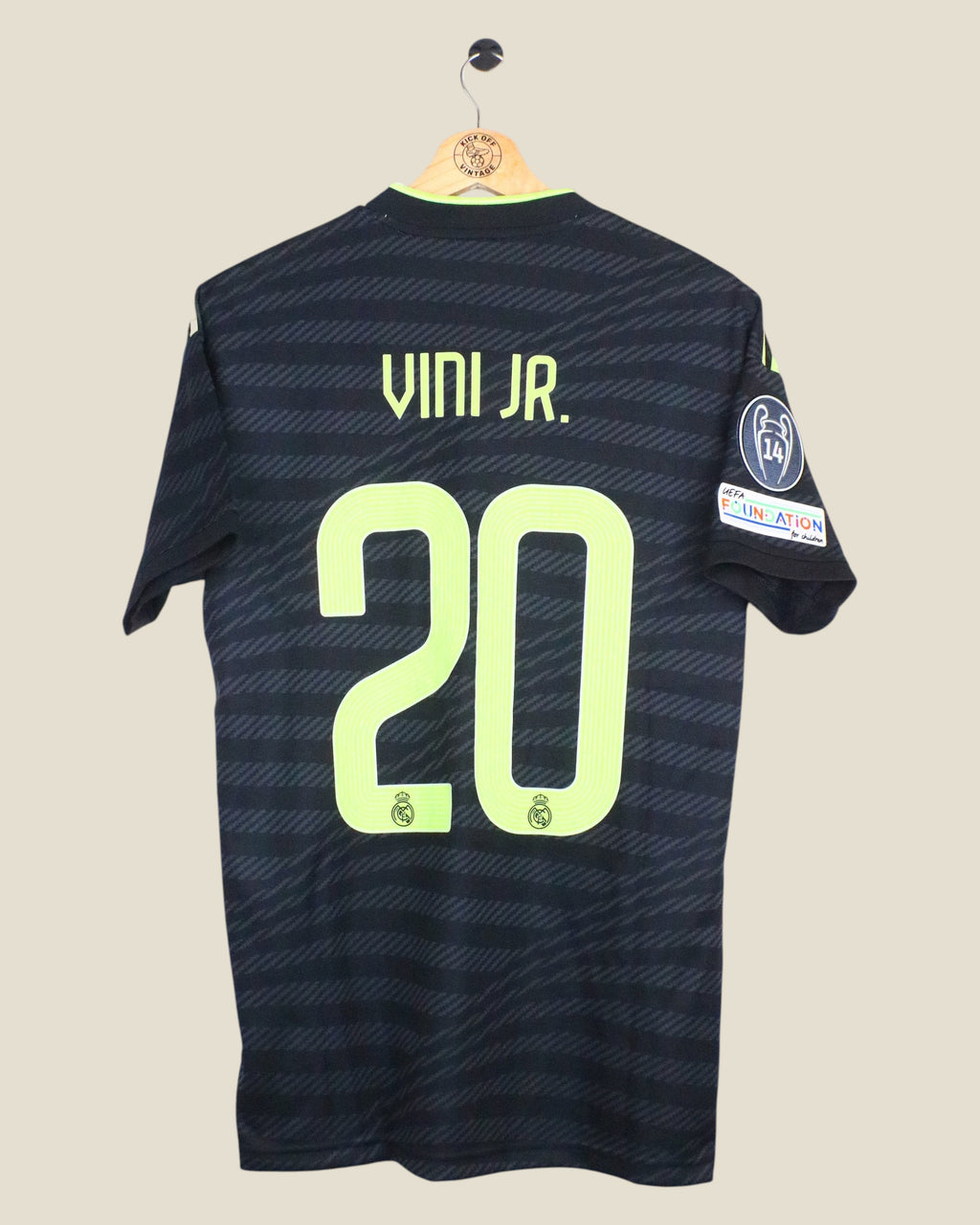 Kick Off Vintage Real Madrid 2022/23 Vinicius Jr third jersey in black with lime green lettering and UCL patches.