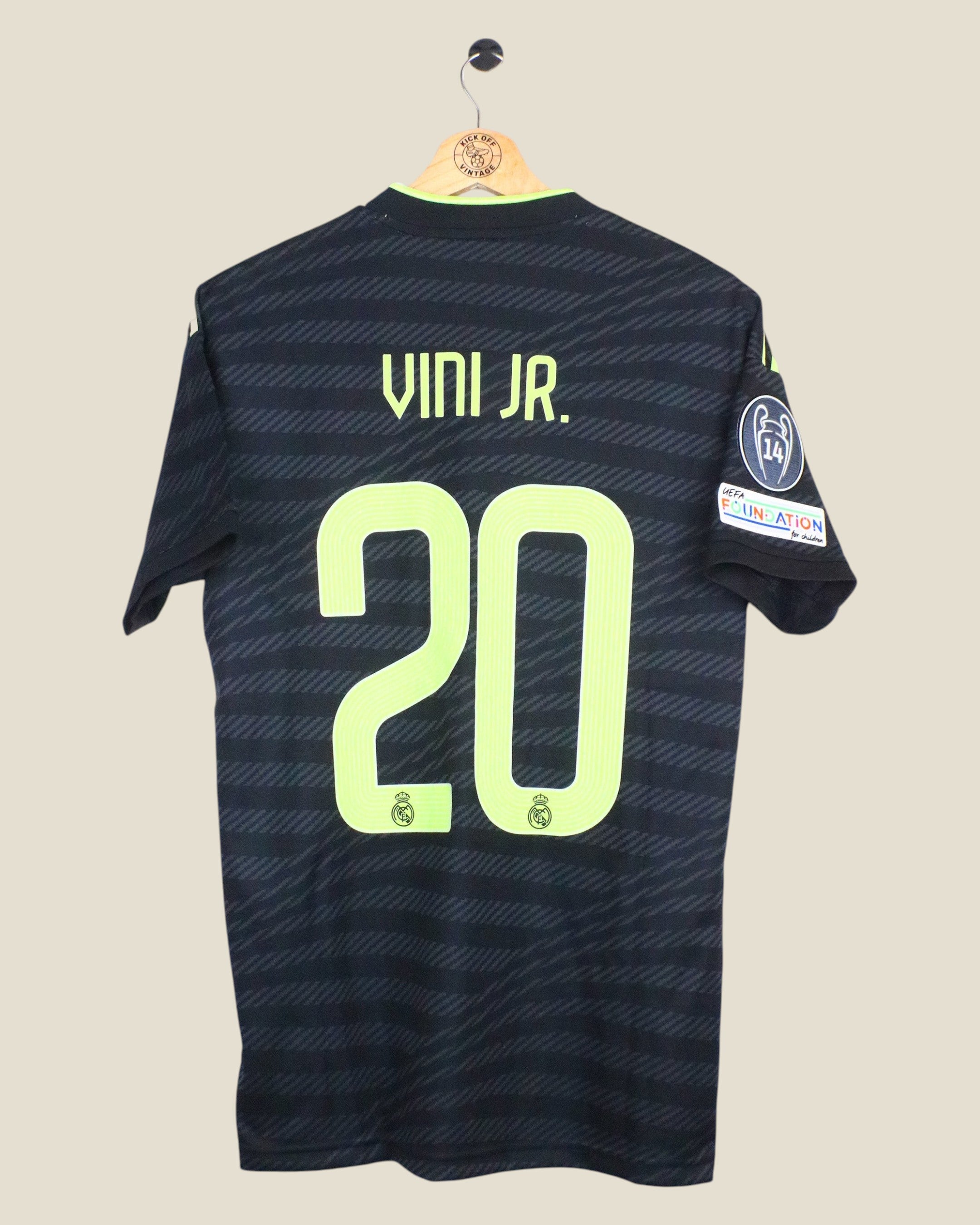 Kick Off Vintage Real Madrid 2022/23 Vinicius Jr third jersey in black with lime green lettering and UCL patches.