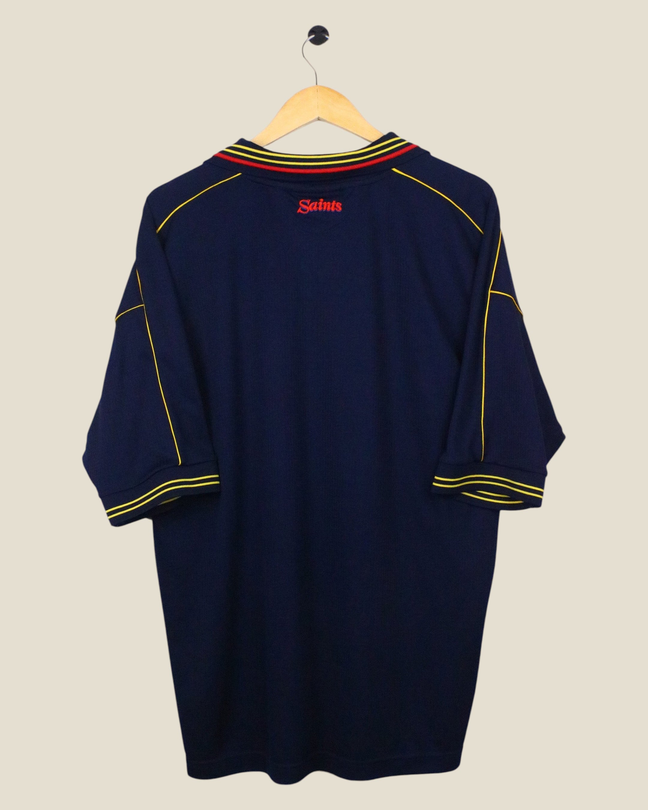 Kick Off Vintage Southampton 1999-01 away football shirt in navy blue with yellow and red trim on a wooden hanger